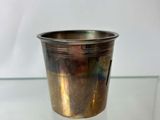 silver plated cup on glass table with white background