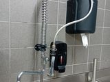 a sink with a faucet and a soap dispenser attached to it