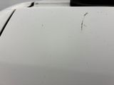 a white car with a rusted hood and a black handle