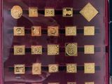a display of gold coins in a case on a table