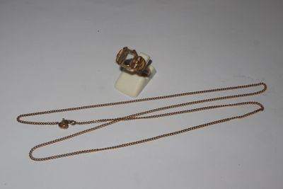necklace and ring with chain on white surface