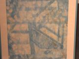painting on the wall of a room with a chair and a table