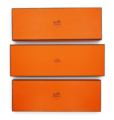 three orange boxes are stacked on top of each other