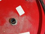 a close up of a red drum with a black hose