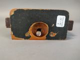 a small piece of wood that has a hole in it