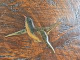a bird that is sitting on a wooden table
