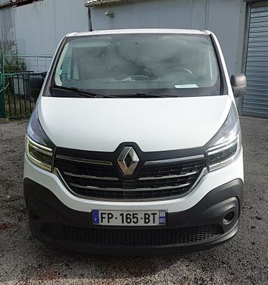 a white van parked in front of a building
