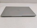 the laptop is sitting on a white surface with a white background