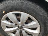 a white car with a flat tire on the side of the road