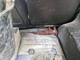 a bag of cement in the back seat of a car