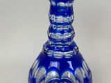 a blue glass vase that is sitting on a table
