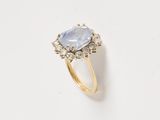 an image of a ring with a blue stone surrounded by diamonds