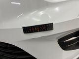a close up of a white car with a sticker on the front of it