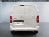 the rear of a white van is parked in a room