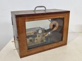 a small wooden box with a machine inside of it