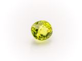 a yellow sapphire stone on a white background