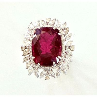 an image of a ruby and diamond ring on a white surface