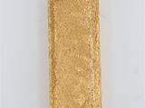a gold cigarette case sitting on top of a white surface
