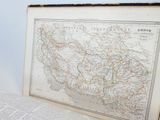 an old map of the united states in a frame on a book