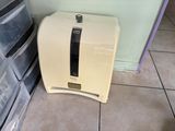 a toaster sitting on the floor next to a stack of boxes
