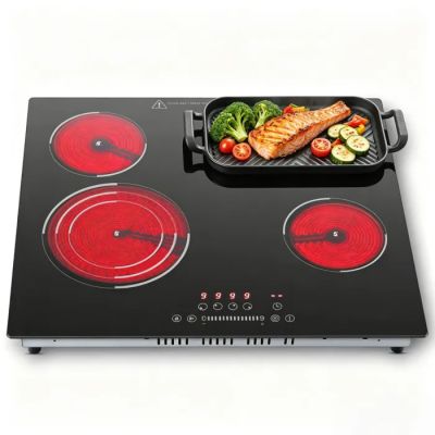 a black and red stove top with a pan of food on it