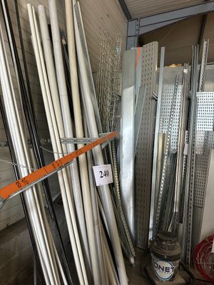 many different types of metal pipes in a storage area