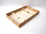 a cardboard box with a tie in it on a white surface