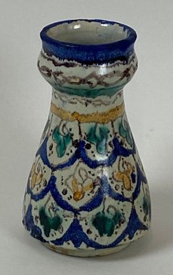 a blue and white vase sitting on a white surface