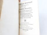 someone is holding a book open to show the title of the book