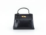 un sac à main en cuir noir sur fond blanc