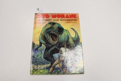 un gros plan sur un livre orné d'un dinosaure