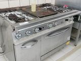 a kitchen with a stove, oven, and sink in it