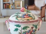 a bowl with a lid sitting on a table in a living room
