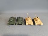 three toy army tanks are lined up on a table