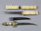 three different types of knifes are displayed on a table