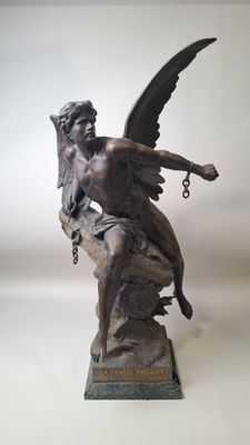 statue of an angel on a rock with a chain around his neck