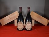 two bottles of wine sitting next to each other on a table