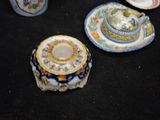 many plates and cups on a black surface