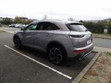 a silver car parked in a parking lot with other cars