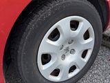 a close up of a red car with a flat tire