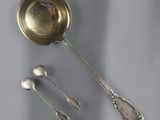 two spoons and a spoon rest on a table