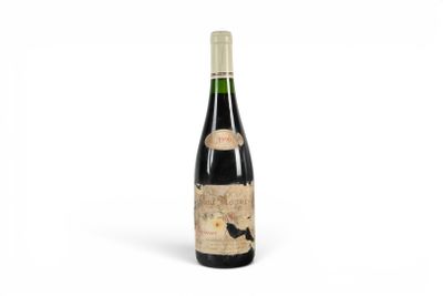 a bottle of wine sitting on top of a white surface