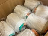 many rolls of white yarn in a cardboard box