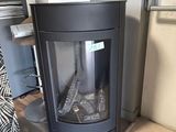 a fireplace in the corner of a room with a tv