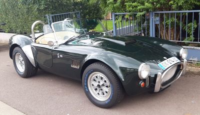 a green sports car parked on the side of the road