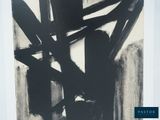 a black and white painting on the wall of a room