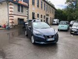 a car parked in front of a building with cars parked in front of it