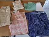 several pairs of shorts are laid out on a cardboard box