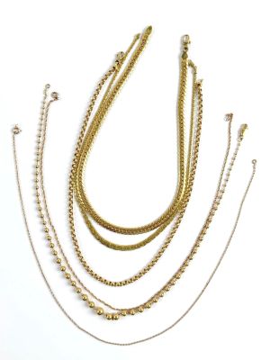 a group of gold chain necklaces on a white background