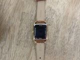 a watch that is sitting on a wooden table